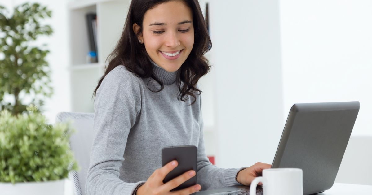 Woman smiling at digital content on agilitycms.com