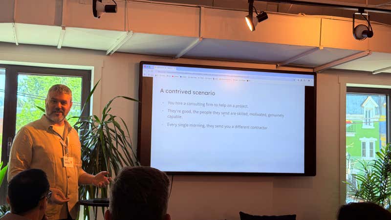 Slide comparing working with AI agents to a consulting firm that sends a different capable contractor every morning