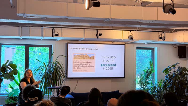 Slide showing OpenAI 2025 losses expressed as USD 1,221.78 per second, citing Ed Zitron reporting