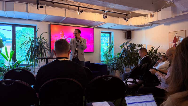 Attendees seated in a plant-filled Montreal coworking space as a keynote speaker presents at CMS Connect 2026
