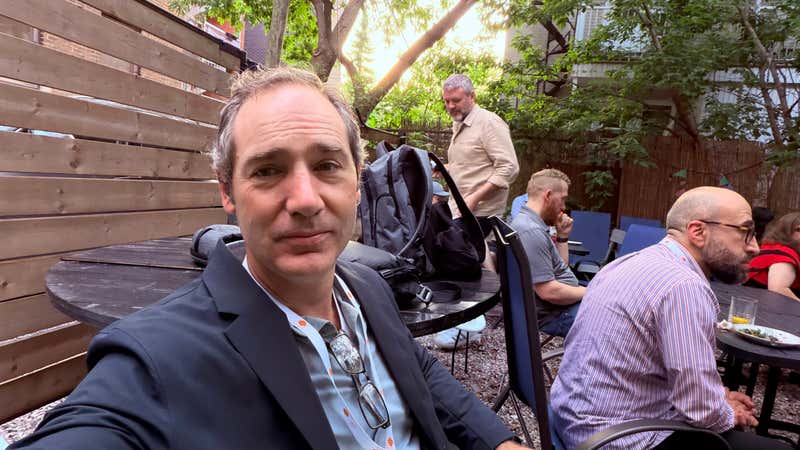 Attendees gather on a leafy Montreal patio at golden hour after day one of CMS Connect 2026