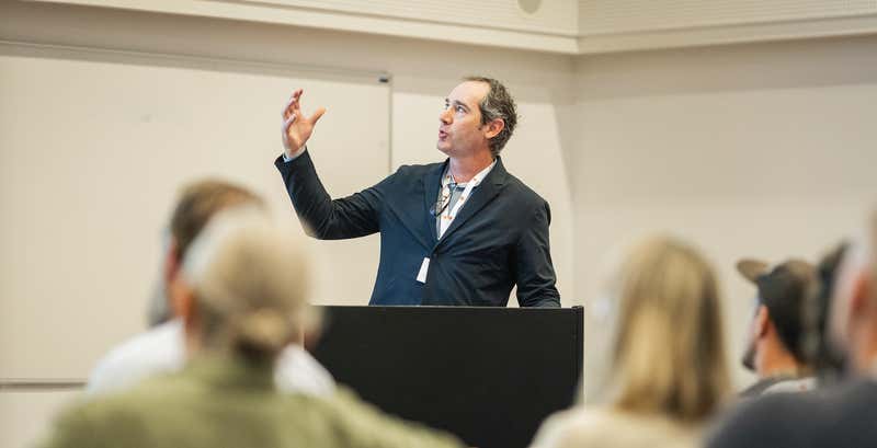 Joel Varty at a conference presenting ideas