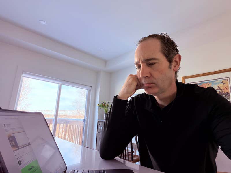 Joel sitting in front of an iPad